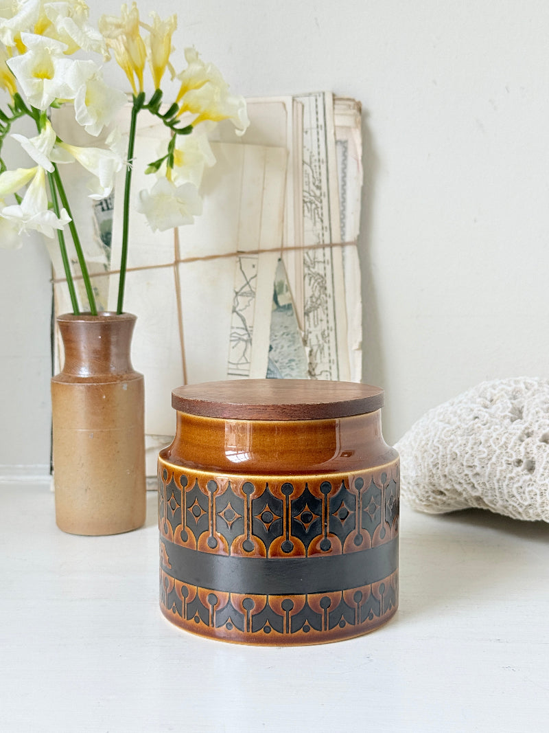 Hornsea Heirloom tea storage jar in autumn brown stoneware with teak lid photographed on a white surface