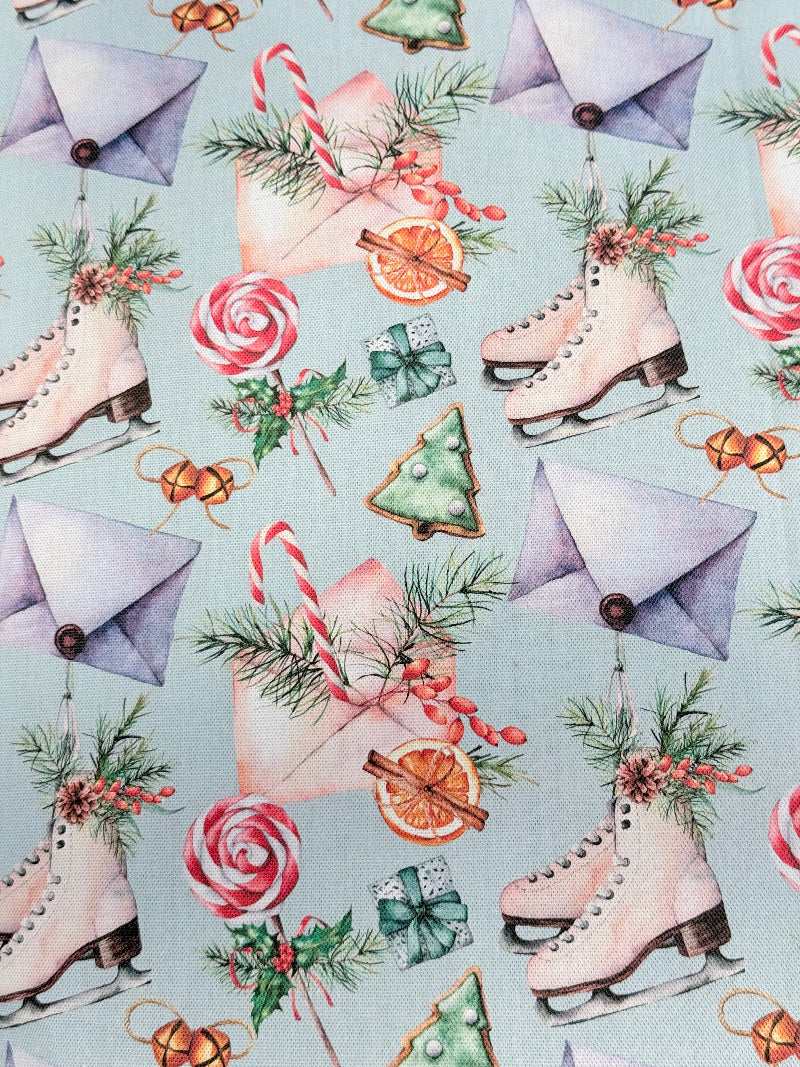 Blue Loft Christmas cotton tea towel with ice skate and candy pattern photographed on a white surface.