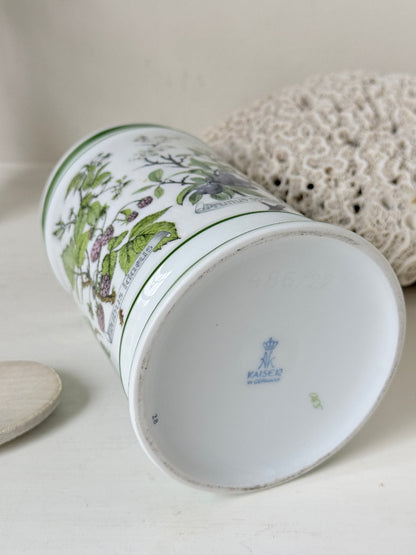 Vintage Kaiser W Germany porcelain utensil jar with botanical floral pattern and green rim photographed on a white surface