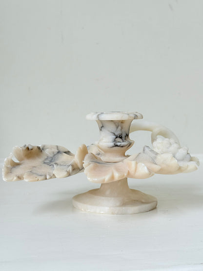 Antique alabaster marble floral candleholder with carved leaves and flowers, photographed on a white surface.