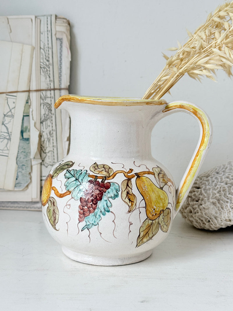 Vintage Deruta Italian hand painted maiolica jug with fruit and vine motif, yellow rim and Mediterranean ceramic styling