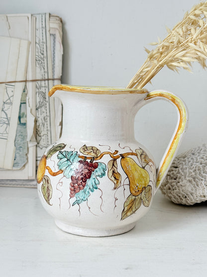 Vintage Deruta Italian hand painted maiolica jug with fruit and vine motif, yellow rim and Mediterranean ceramic styling
