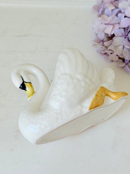 Vintage Sylvac swan planter in white ceramic with yellow beak and feet, styled on a white surface