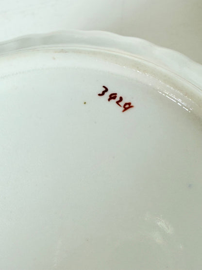 vintage porcelain sugar bowl with coral transfer design and gilt rim on white surface