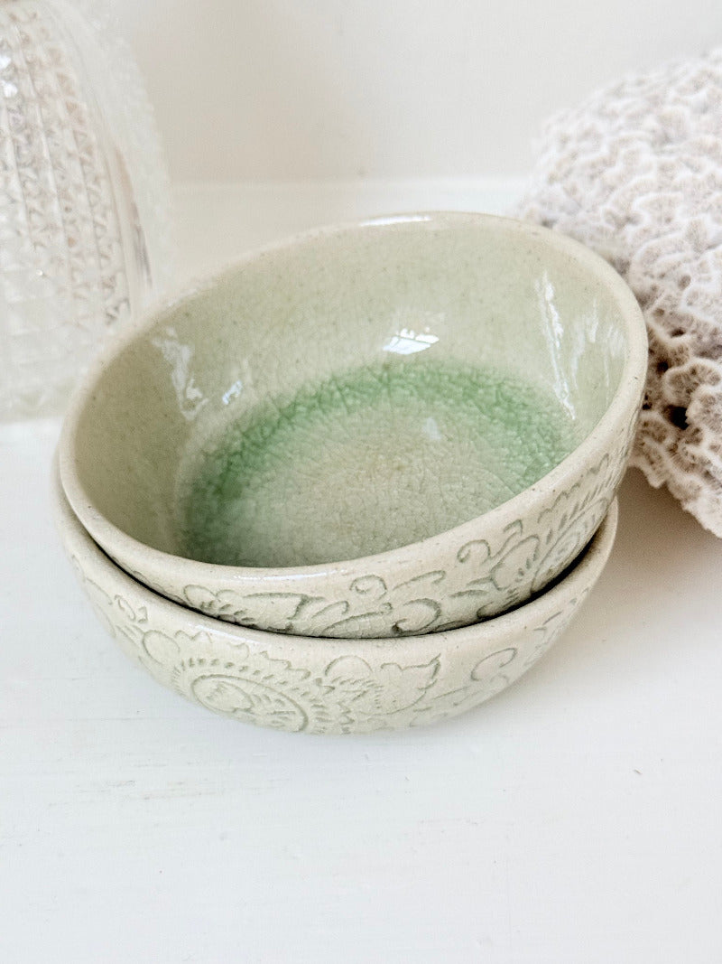 Pair of sage green Thai celadon olive bowls with crackled glaze, photographed on white surface