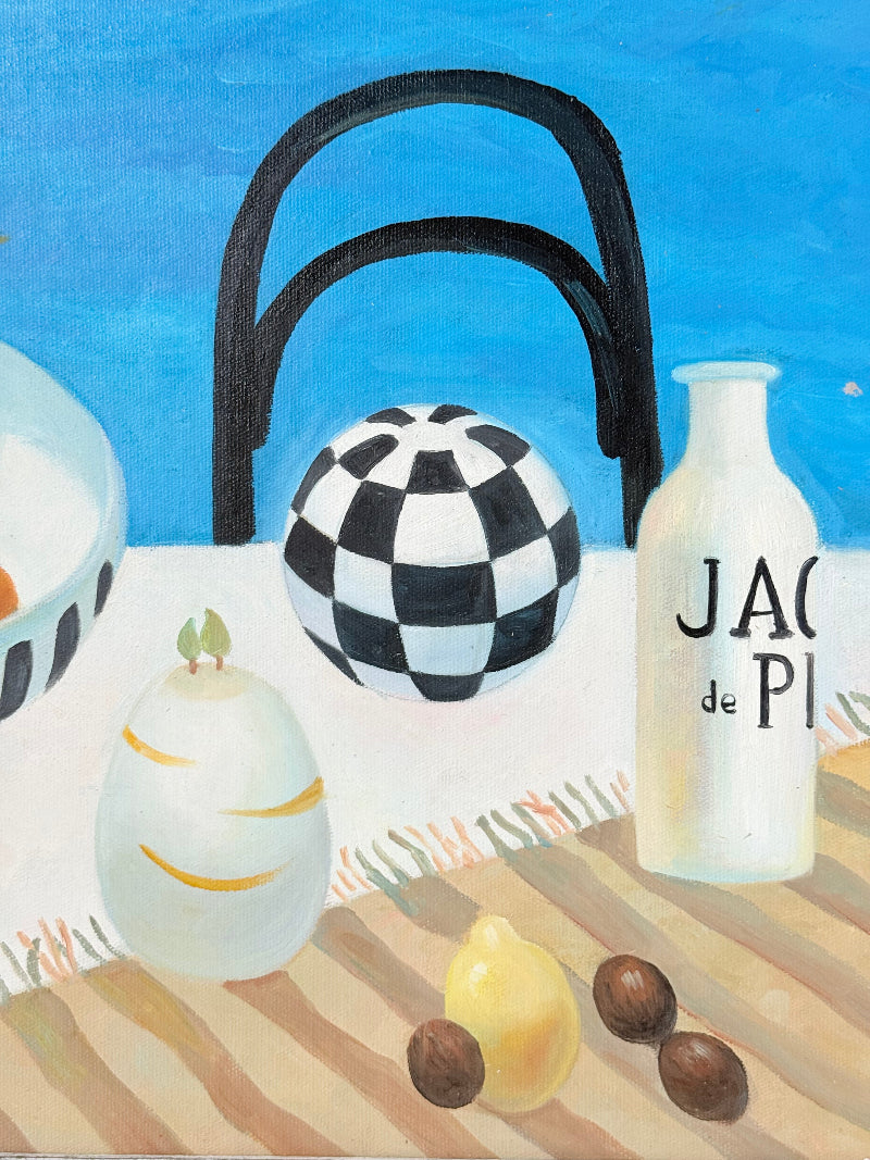 Still life oil painting showing fruit bowl and striped jug on a blue background, framed in white wood, photographed on a white surface.