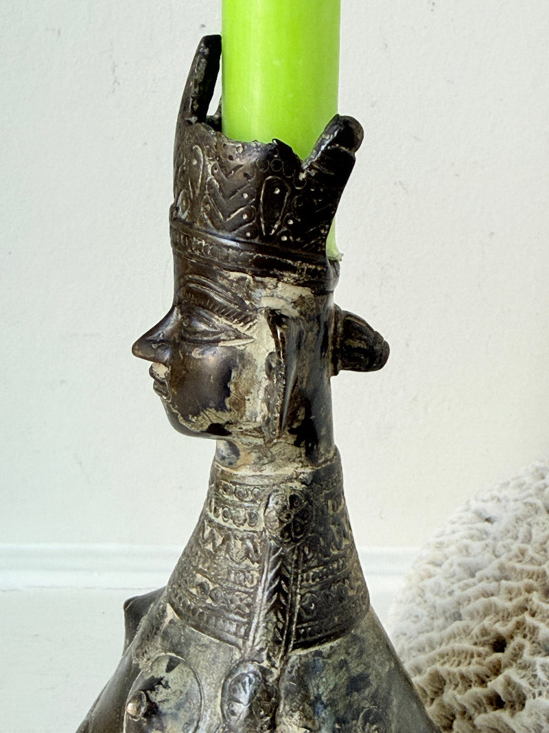 Antique Bengali anthropomorphic brass ritual vessel with goddess figure and lobed headdress, on a white surface