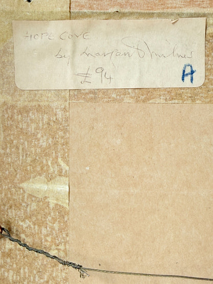 A close-up of a vintage art print or card mounted on a textured beige wall. The top portion shows a handwritten label reading &