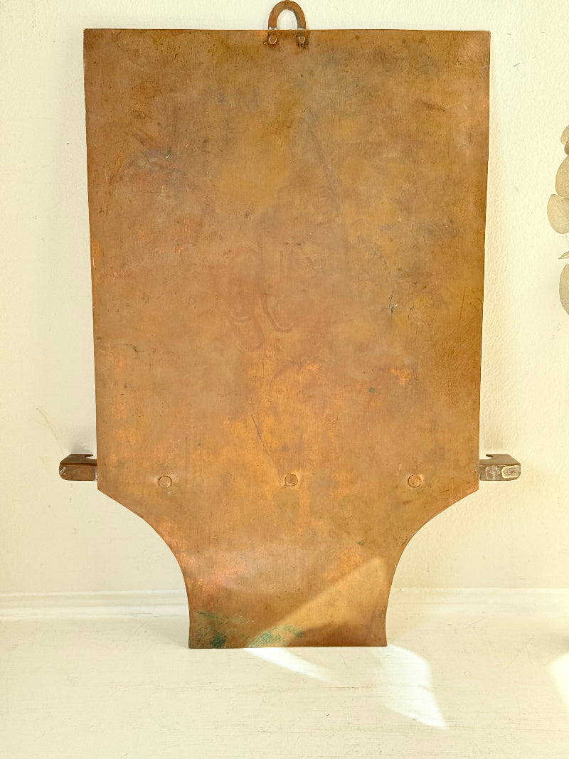 Vintage hanging copper pipe stand with hand etched design, ideal for holding utensils, tools or dog leads, photographed on a white surface beside dried stems.