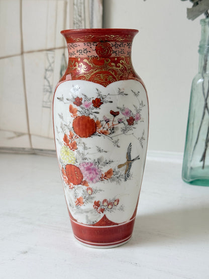 Japanese Kutani porcelain vase hand painted with flowers in white panels on an iron red and gold ground