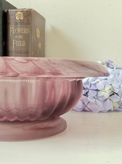 Davidson Cloud Glass bowl in amethyst with swirl pattern and footed base, styled with books and hydrangeas