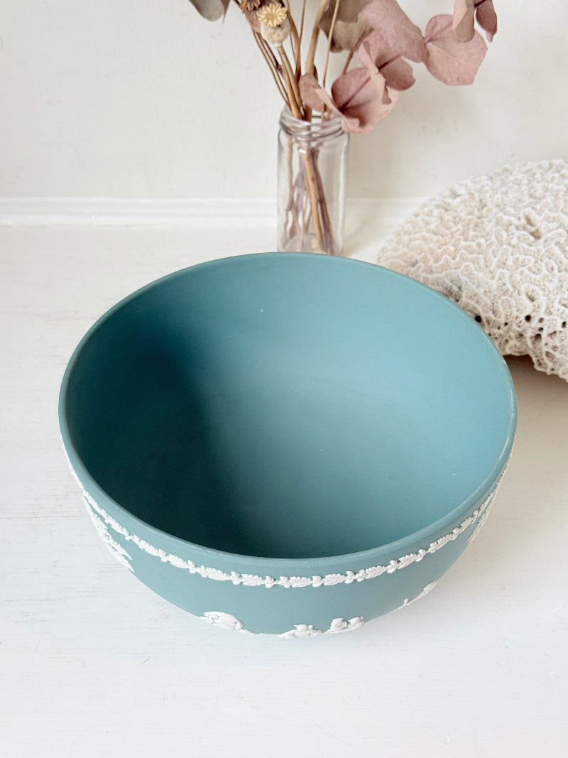 Large vintage Wedgwood Jasperware teal green fruit bowl decorated with white classical figures beneath stylised trees and a laurel garland border.