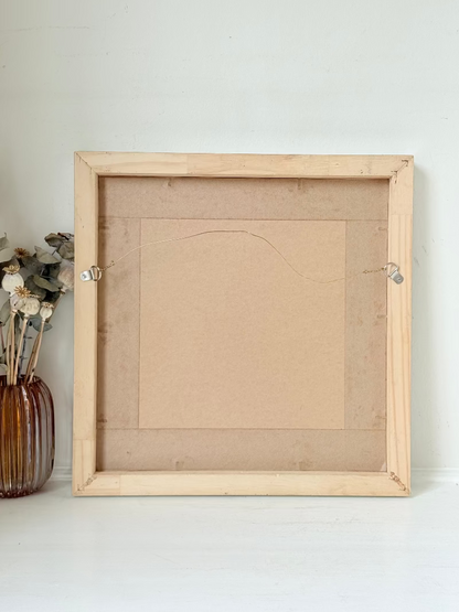 Mixed media painting by Watkiss of figures in a train carriage, framed in white, photographed on a white surface