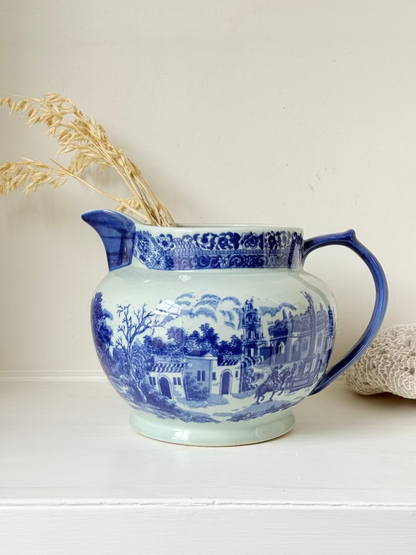 Vintage large ironstone jug with blue and white transferware decoration, photographed on a white surface