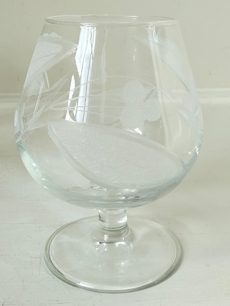 Set of six vintage etched Bailey’s glasses with rounded bowls and short stems, photographed on white surface.