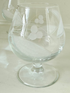 Set of six vintage etched Bailey’s glasses with rounded bowls and short stems, photographed on white surface.