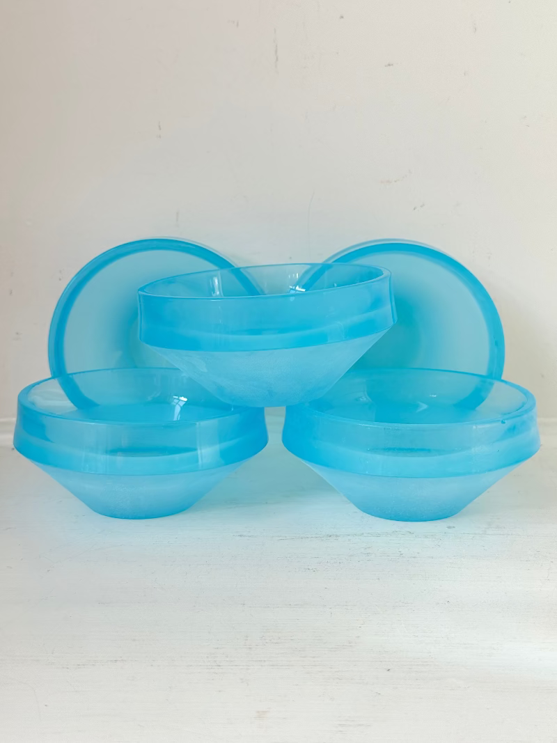 Set of six vintage turquoise midcentury glass bowls with smooth sides, photographed on white surface.
