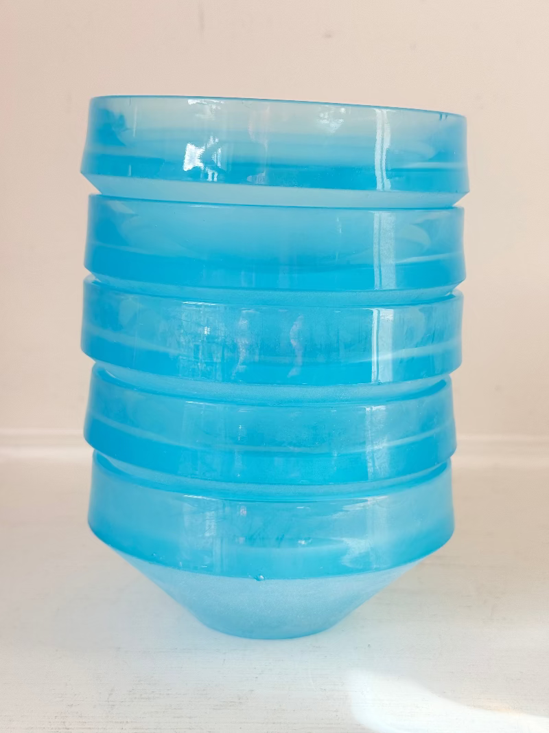 Set of six vintage turquoise midcentury glass bowls with smooth sides, photographed on white surface.