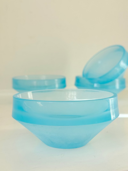 Set of six vintage turquoise midcentury glass bowls with smooth sides, photographed on white surface.