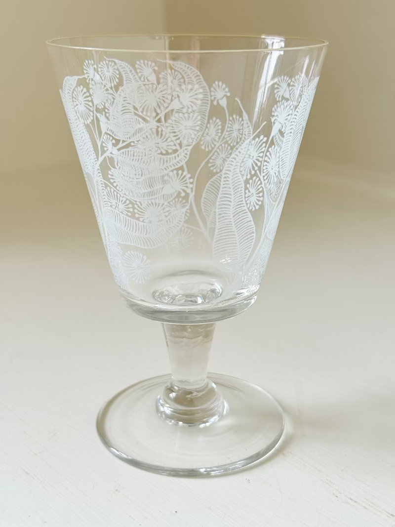 Set of six vintage wine glasses with white floral printed design, photographed on white surface.