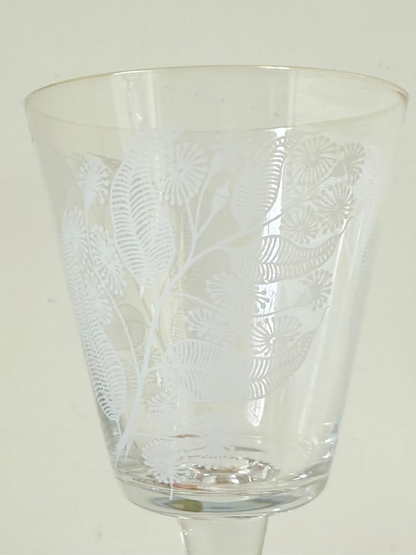 Set of six vintage wine glasses with white floral printed design, photographed on white surface.