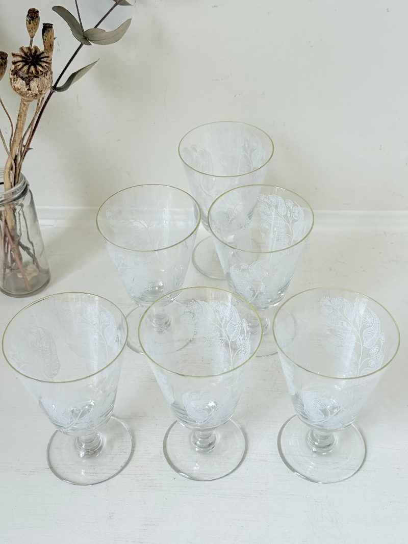 Set of six vintage wine glasses with white floral printed design, photographed on white surface.