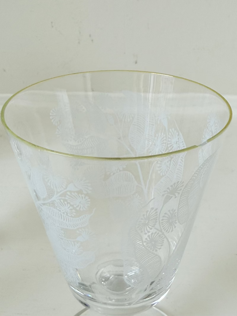 Set of six vintage wine glasses with white floral printed design, photographed on white surface.