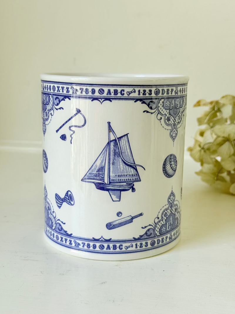 blue and white spode moneybox with sporting scene design, photographed on white surface