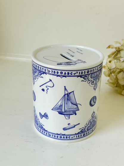 blue and white spode moneybox with sporting scene design, photographed on white surface