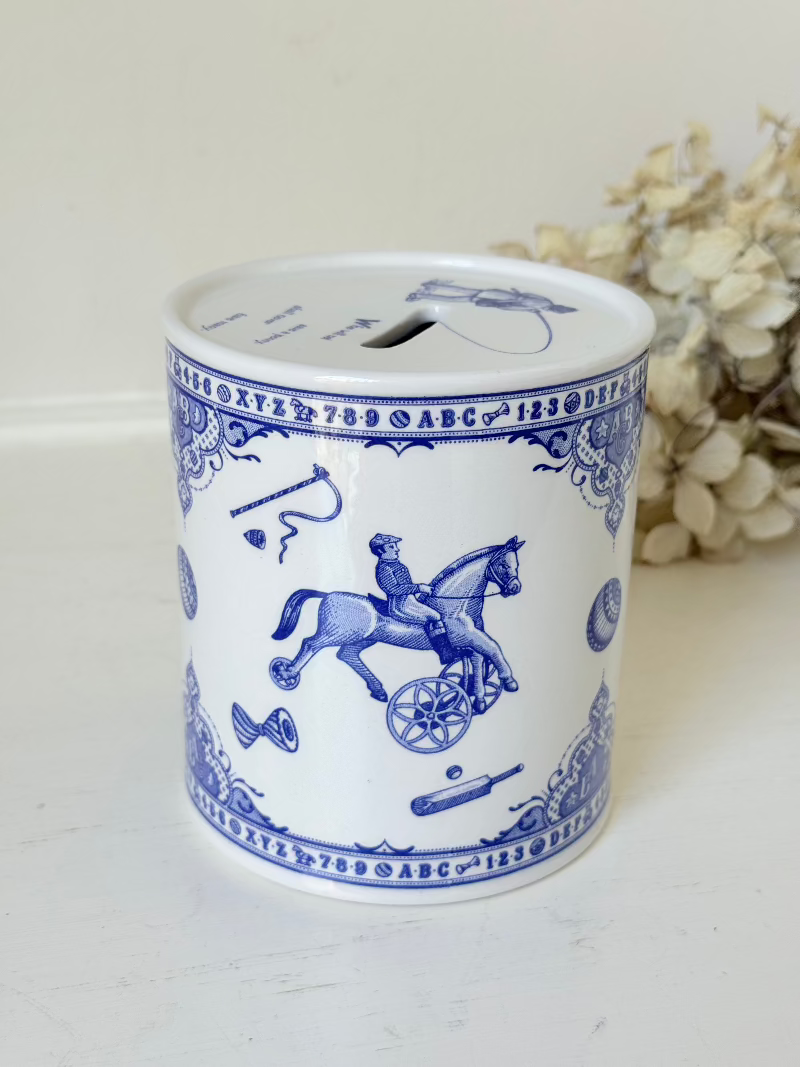 blue and white spode moneybox with sporting scene design, photographed on white surface