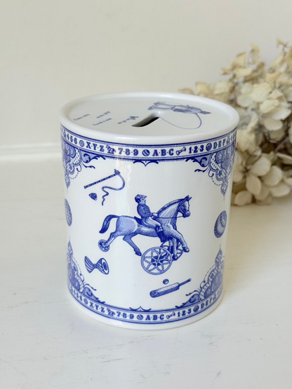 blue and white spode moneybox with sporting scene design, photographed on white surface