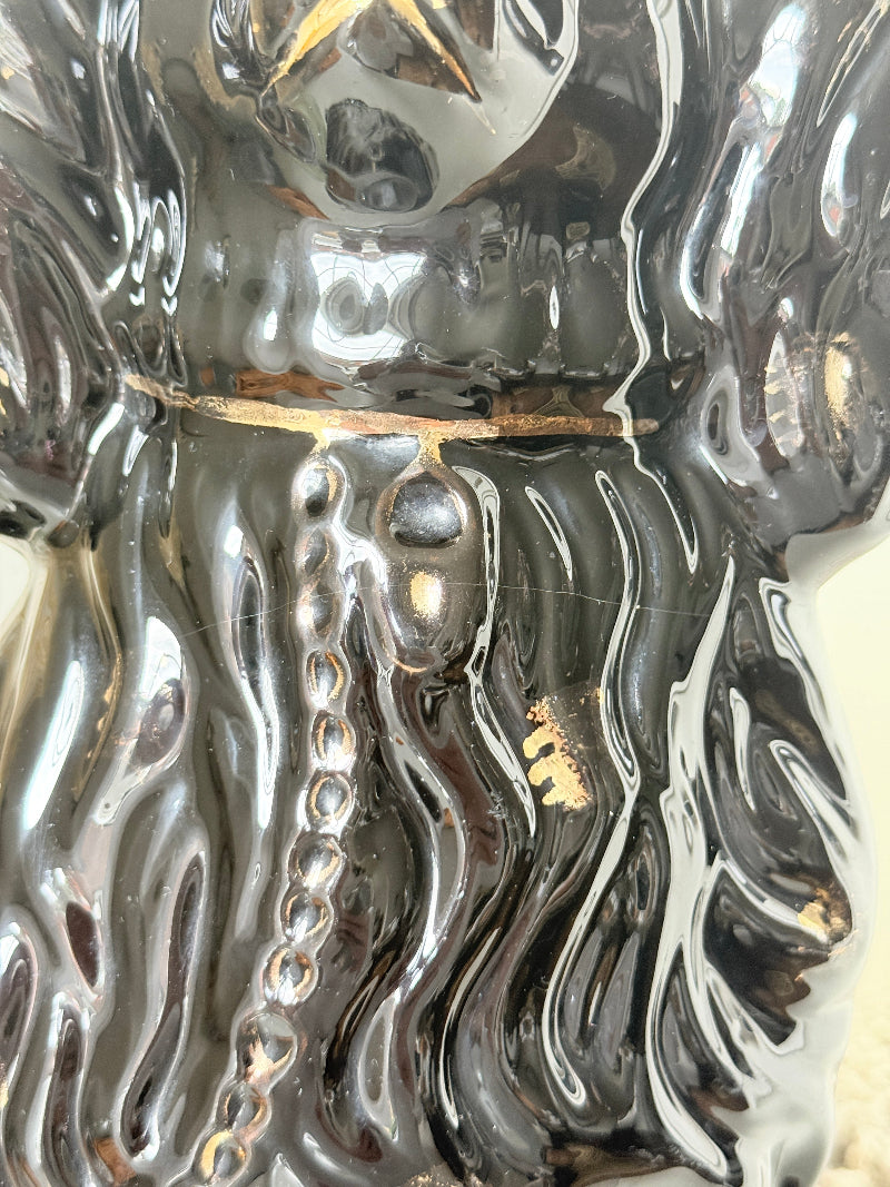 Vintage Staffordshire style black ceramic spaniel dog with gold lustre collar, glossy glaze and textured coat detail
