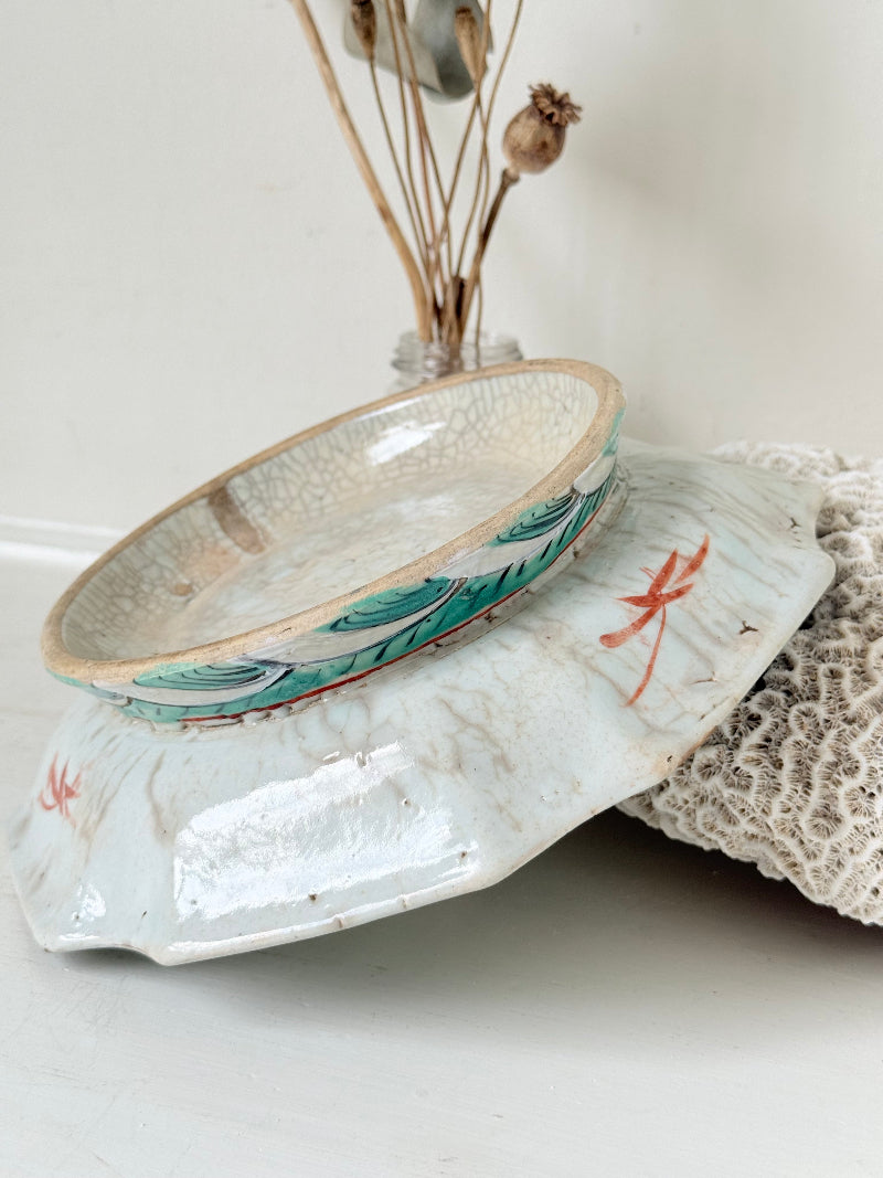 Antique ceramic footed dish with turquoise floral and bird design, photographed on a white surface.