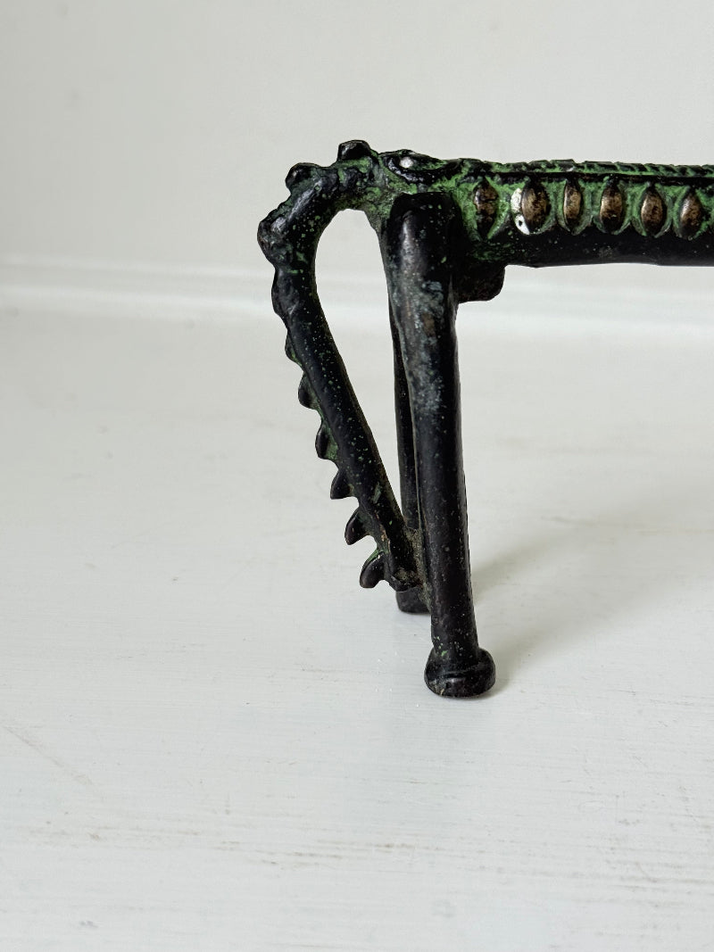 Vintage bronze horse sculpture with green patina, photographed on a white surface.