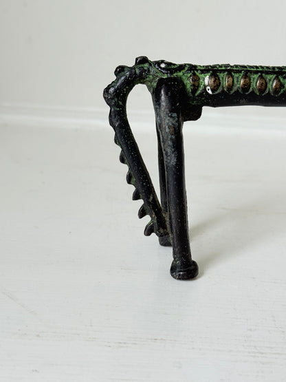 Vintage bronze horse sculpture with green patina, photographed on a white surface.