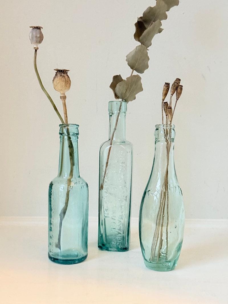 Trio of Antique Aqua Glass Bottles with Embossed Lettering