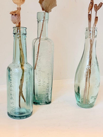 Trio of Antique Aqua Glass Bottles with Embossed Lettering