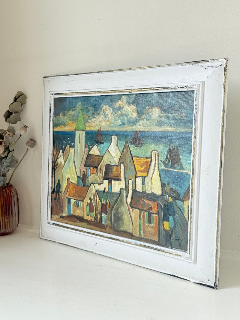 Mid century Irish school oil painting of seaside village, blue and ochre tones, photographed on white surface