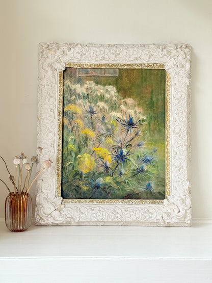 Framed floral oil painting on board by Muriel Hester Broughton, 1970, shown on a white surface with decorative carved frame