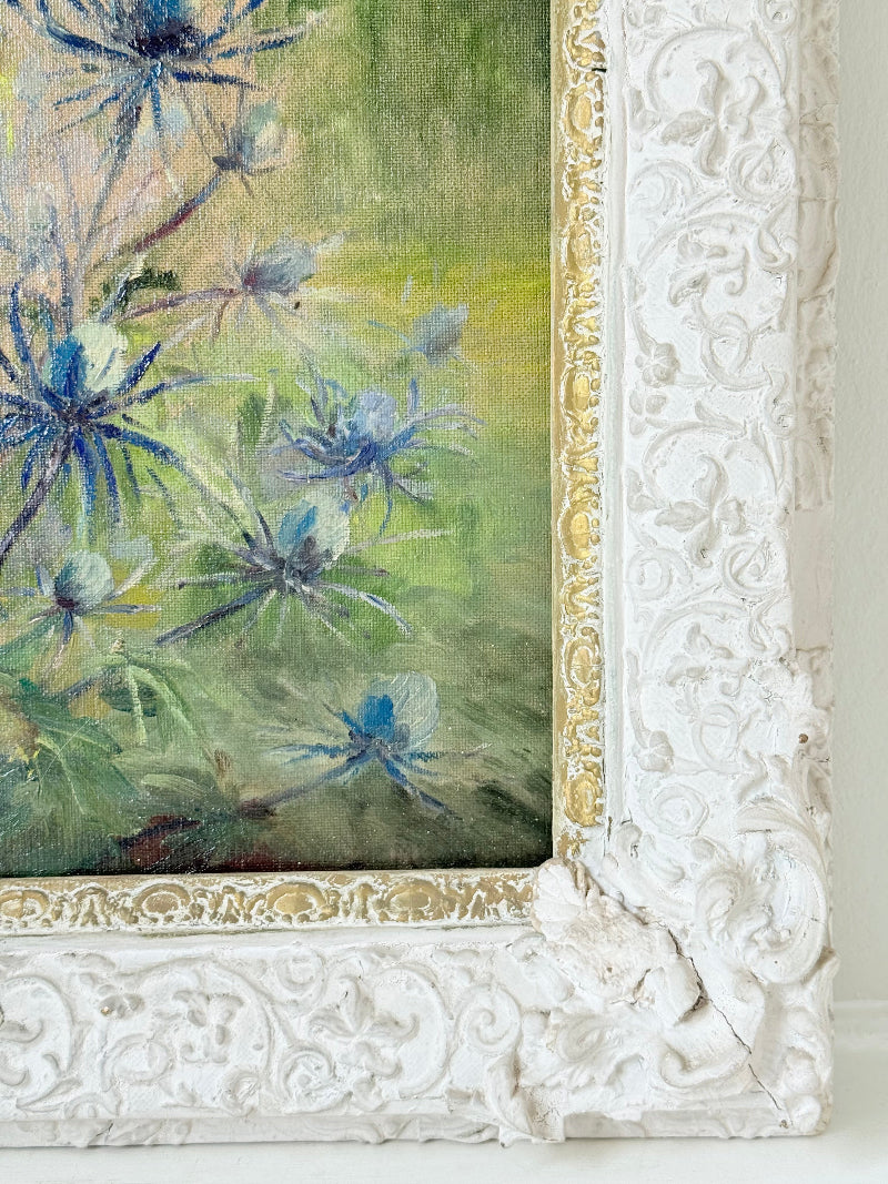 Framed floral oil painting on board by Muriel Hester Broughton, 1970, shown on a white surface with decorative carved frame