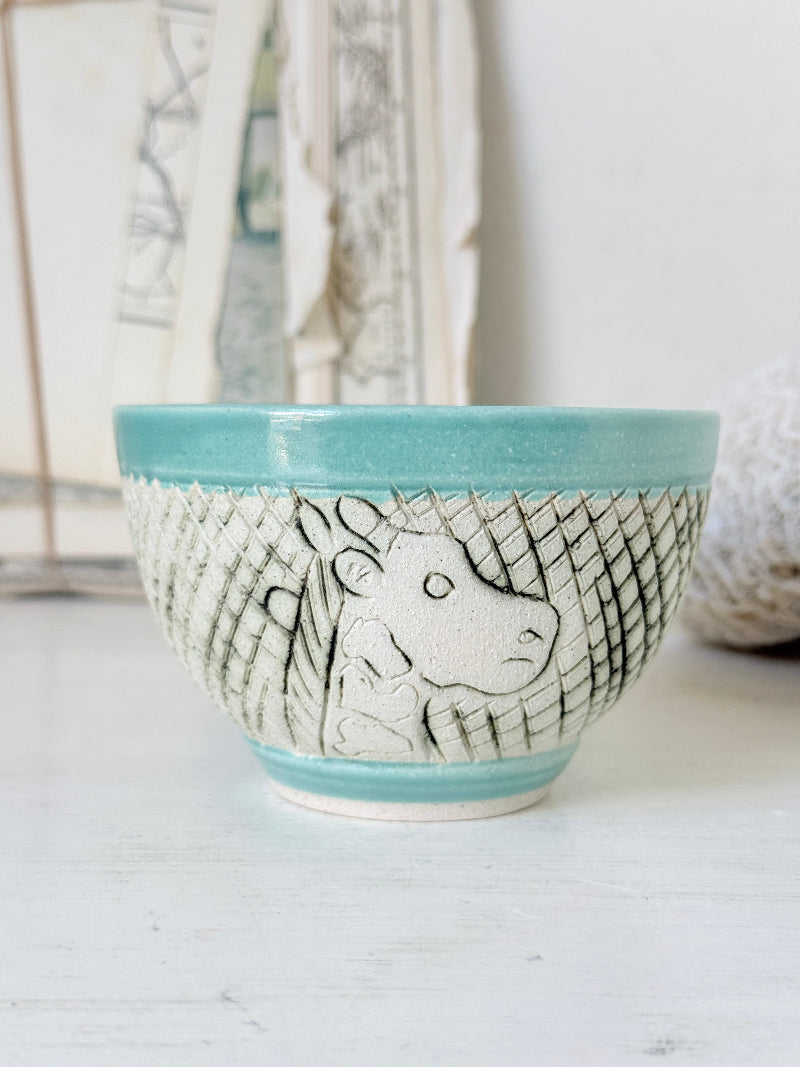 Studio pottery bowl in turquoise with hand decorated giraffe