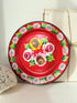 Rim of a vintage enamel plate painted with white daisies and green leaves