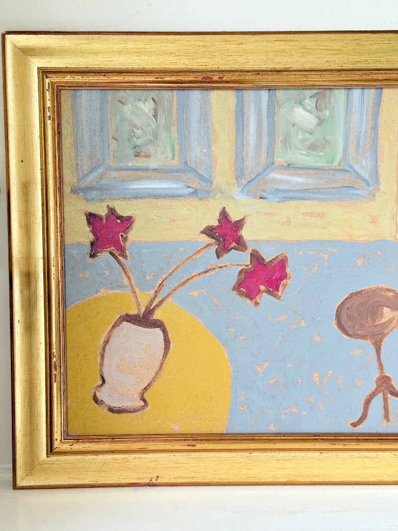 Naïve interior oil painting with red flowers in a vase, in golden frame, styled on a white dresser with neutral background