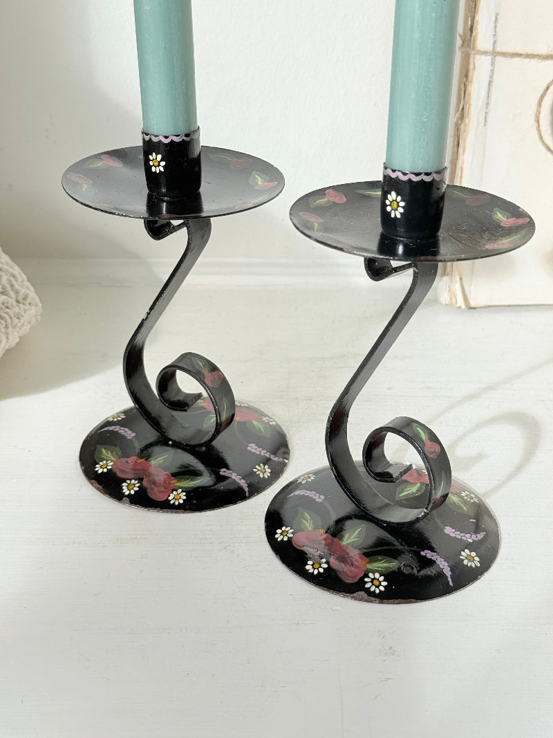 Pair of vintage black toleware candlesticks hand painted with pink roses and daisies