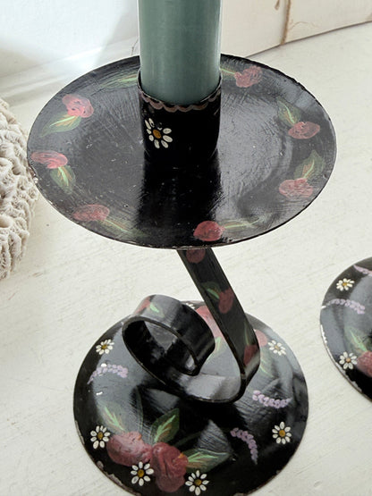 Painted folk art candlestick in black with pink roses, side view