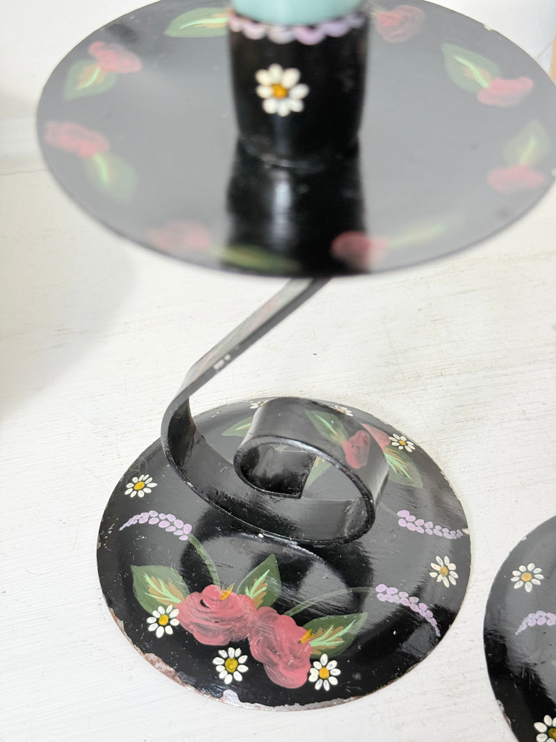 Black toleware candlestick base painted with roses, daisies and lilac