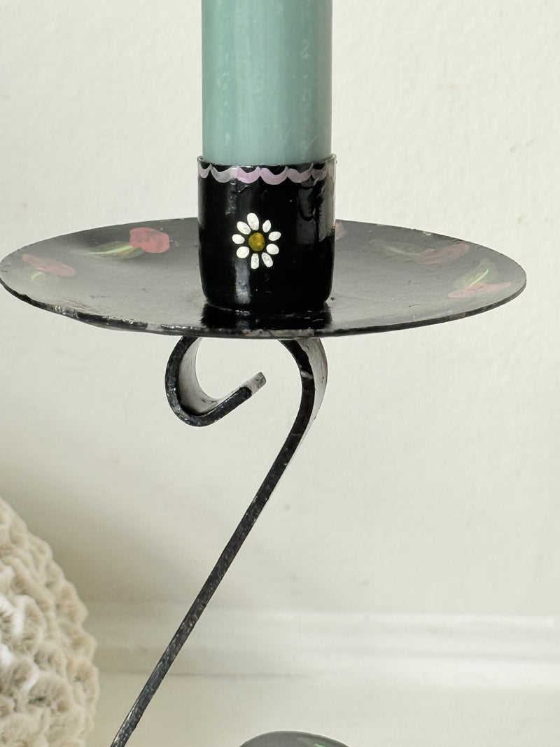 Close up of hand painted daisy on a black toleware candle cup