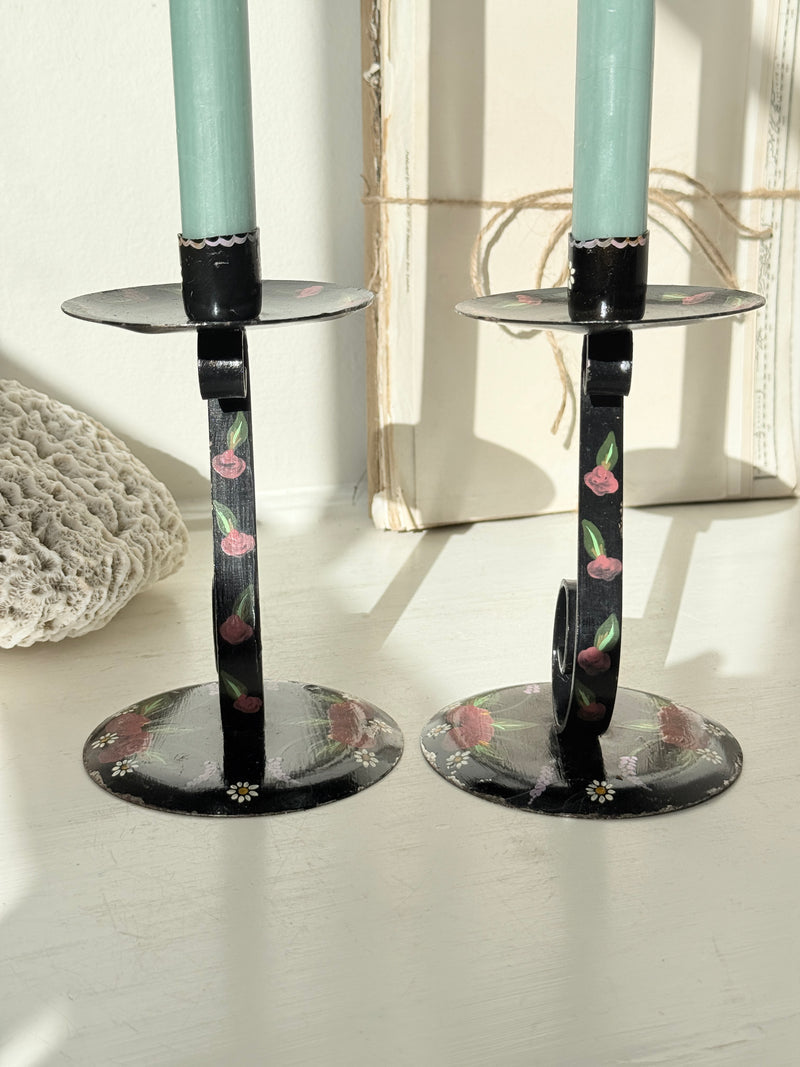 Pair of black folk art candlesticks with hand painted flowers